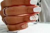 a white manicure with a gold glitter chevron and a gold glitter accent nail is a very elegant and fresh option