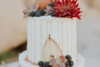a wihte buttercream wedding cake with caramel drip, a bold bloom, pears and succulents, blackberries is a cool idea for the fall