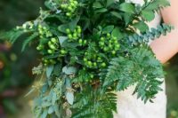 all-green cascading wedding bouquet with ferns and eucalyptus and berries for a chic woodland look