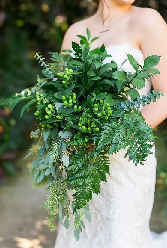 all-green cascading wedding bouquet with ferns and eucalyptus and berries for a chic woodland look