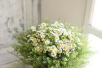 an amazing summer wedding bouquet of daisies and greenery is a very chic and very simple idea for a boho or rustic summer wedding
