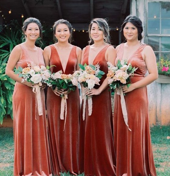 beautiful matching bridesmaid dresses in pink, peachy, orange and rust velvet, with deep necklines and thick straps are gorgeous
