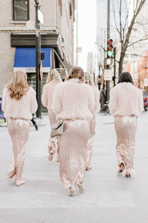 blush fuzzy coats matching blush sequin bridesmaid dresses and creating a tender and trendy look