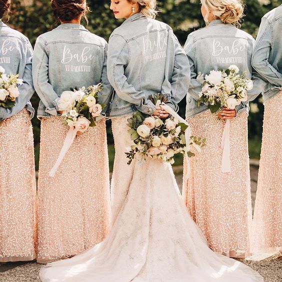 custom painted denim jackets for the bride and bridesmaids in light blue add a relaxed feel to the outfits