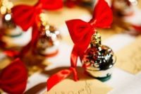 display your escort cards with little ornaments with red bows that will double as favors