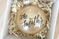 give your guests large metallic ornaments with your second name and wedding date, they will remind of your wedding