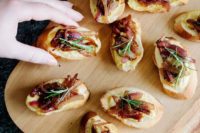 hummus and caramelized onion crostini with some rosemary on top are a delicious idea for a cold seaosn wedding