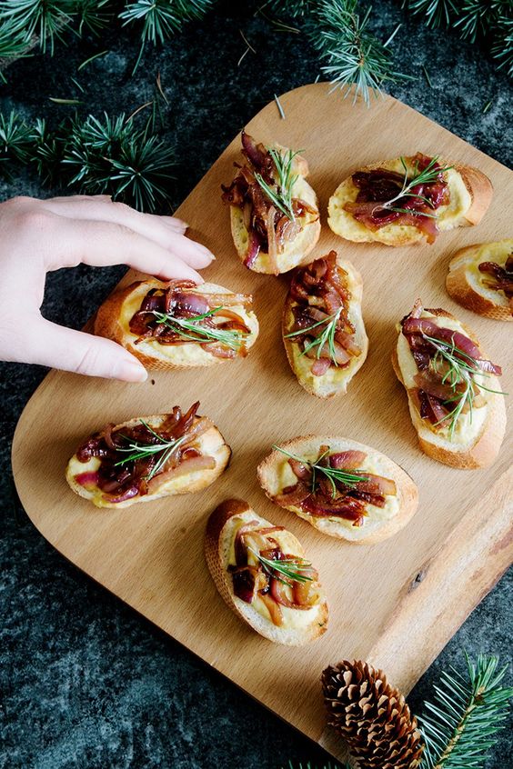 hummus and caramelized onion crostini with some rosemary on top are a delicious idea for a cold seaosn wedding