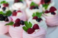 mini pavlova desserts topped with fresh berries and herbs are delicious and very cute-looking