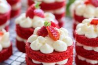 mini red velvet cakes with cream and fresh strawberries on top are amazing for making your wedding sweeter