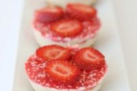 mini strawberry cheesecakes with berry jelly and fresh berry slices on top are very tasty
