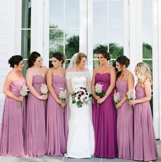 pink strapless maxi dress with pleated skirts and a purple matching gown for the maid of honor