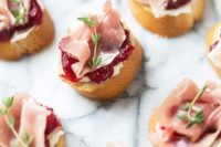 toasts with cranberry jam, cream cheese, proschiutto, herbs for a winter or Christmas wedding