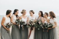 white lace crop tops and dark green maxi skirts for the bridesmaids and a dark green maxi gown for the maid of honor