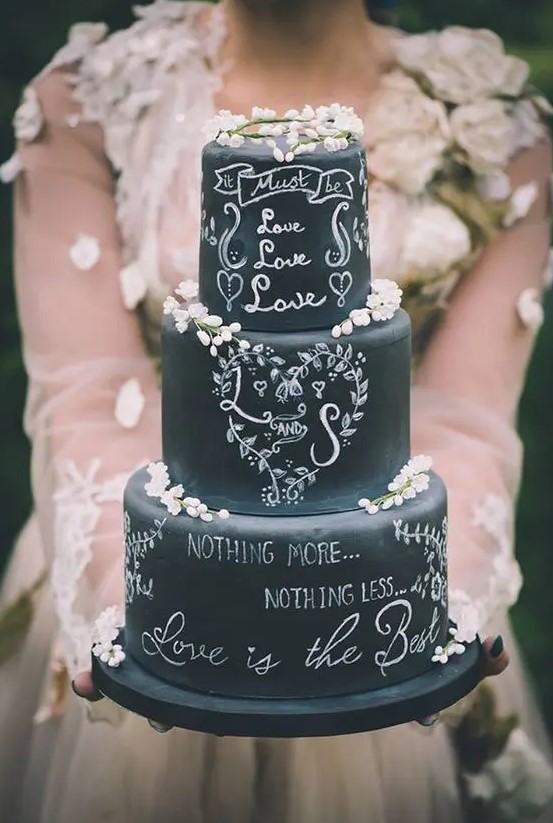 a beautiful chalkboard wedding cake with chalking and some white blooms is a gorgeous idea for any wedding, here blooms are mostly about a spring celebration