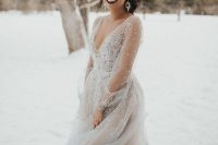 a beautiful grey fully embellished wedding ballgown with a deep neckline and sheer sleeves for a real ice queen