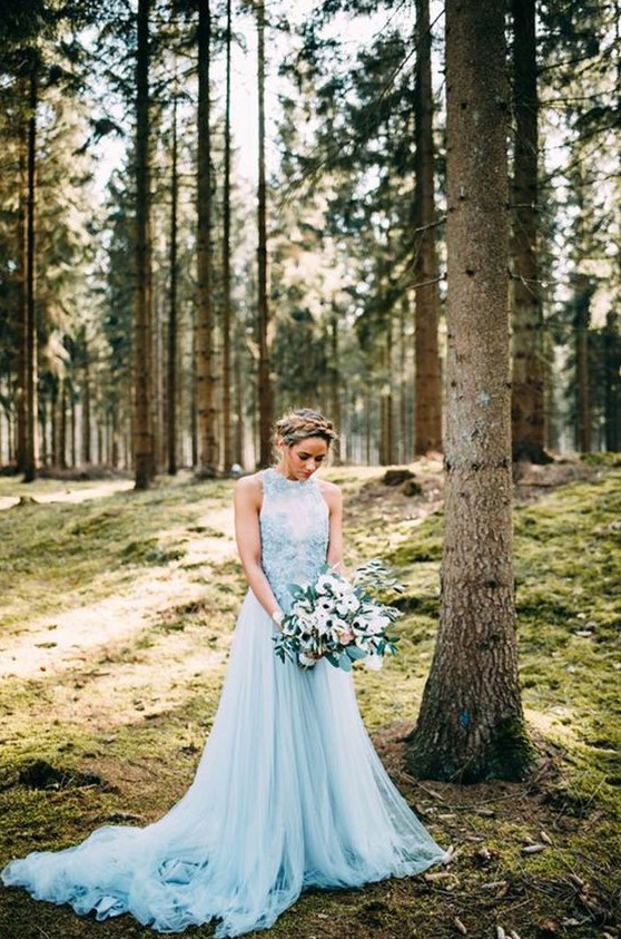 a blue A line halter neckline wedding dress with a lace bodice with floral appliques and a train looks wow