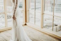 a boho lace two piece wedding dress with a train, a braided updo and statement earrings