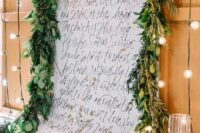 a calligraphy wedding ceremony backdrop with quotes, greenery and pillar candles is amazing for a wedding