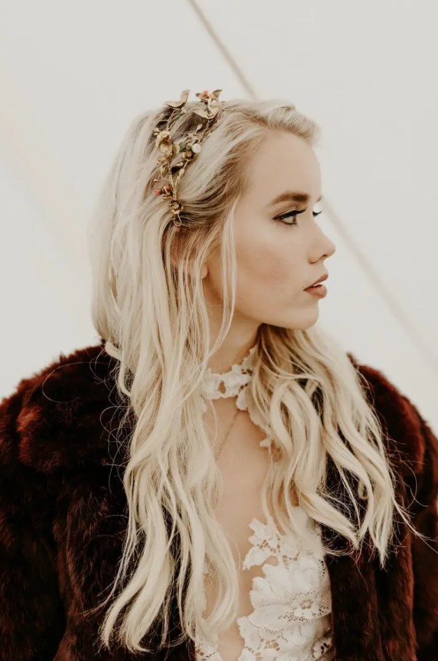 a catchy gold and pearl floral bridal tiara that matches the faux fur coat for a boho bride