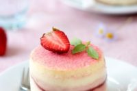 a cherry blossom bite size cheesecake with a fresh strawberry piece on top for a summer or spring wedding