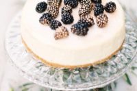 a classic cheesecake topped with gilded blackberries is a yummy dessert that always works