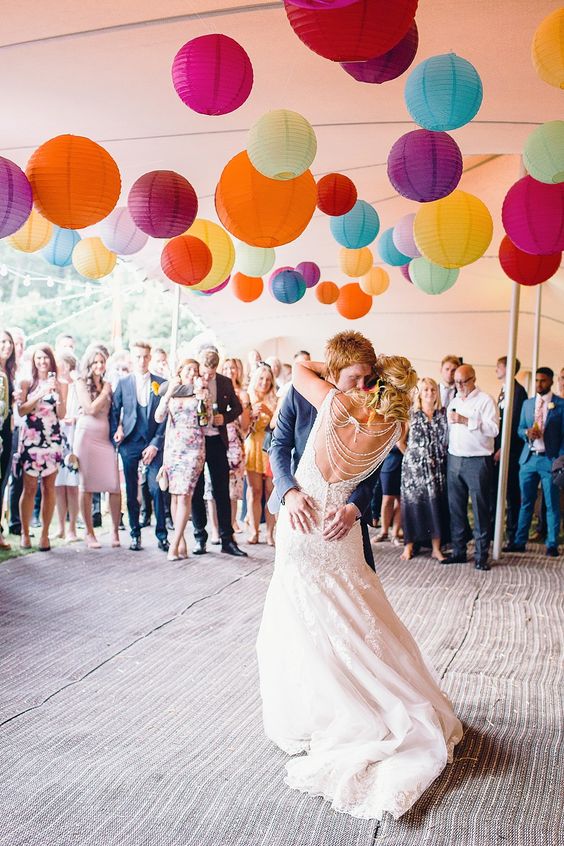 a dance floor accented with lots of colorful paper lanterns looks cool, bold and cute