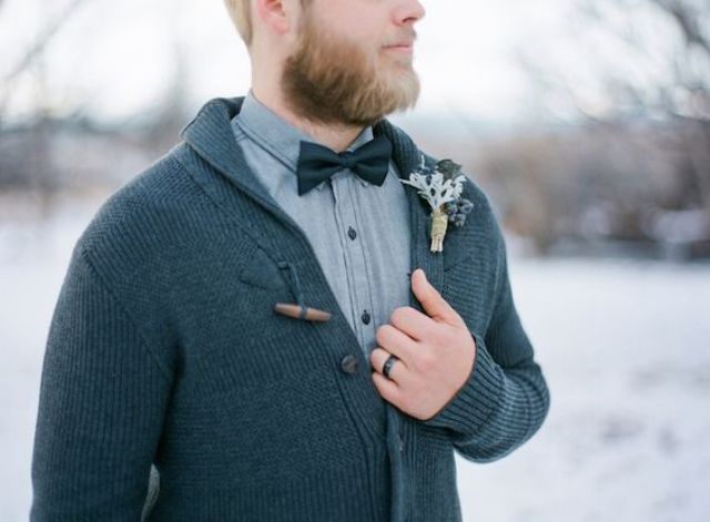 a dark grey cardigan, a grey shirt and a black bow tie for a relaxed winter groom look