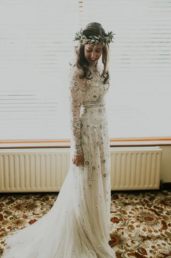 a delicate boho wedding dress with neutral and silver floral embroidery, long sleeves and embellishments looks chic