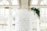 a dreamy wedding backdrop with a quote, white fabric, greenery is a lovely and very romantic idea for a wedding