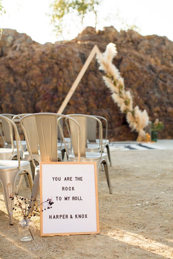 a framed sign with a quote to decorate a boho or rock-n-roll wedding aisle, make some yourself