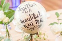 a globe with a quote is a cool wedding decoration if you like to travel and you can DIY one easily