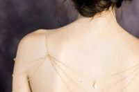 a gold chain and pearl shoulder and back necklace for a strapless wedding dress with an open back