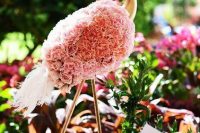 a gold flamingo covered with pink carnations is a very creative and glam decoration for any wedding or wedding-connected event