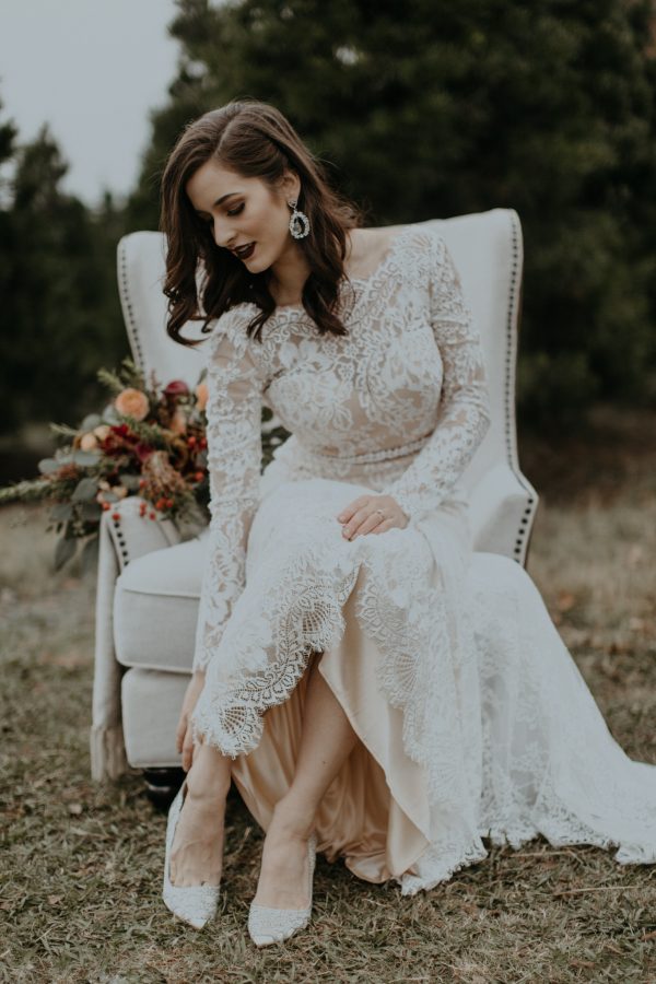 a gorgeous vintage-inspired lace wedding dress with an illusion neckline, long sleeves and an embellished belt