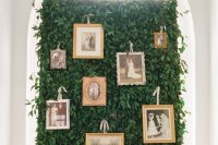 a greenery wall used to display family photos is a lovely and refined idea to rock at the wedding