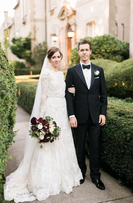 a high neckline long sleeve A line wedding dress of textural lace and with a matching veil