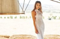 a lace sheath wedding dress with an illusion halter neckline and a train for a romantic modern bride
