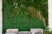 a living wall with greenery, fern and leaves as a wedding lounge backdrop that brings a fresh feel in