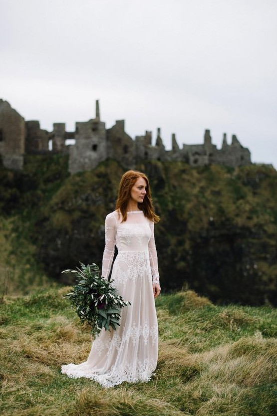 a lovely A line lace wedding dress with an illusion neckline, long sleeves and a train for a castle elopement