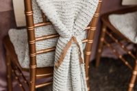 a lovely knit wedding chair cover is a great way to cozy up wedding chairs, whether they are couple’s or not