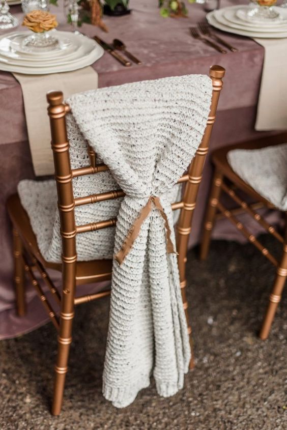 a lovely knit wedding chair cover is a great way to cozy up wedding chairs, whether they are couple's or not
