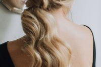 a low wavy ponytail with a messy top accented with a cool shiny star headcomb is a gorgeous idea