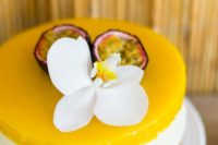 a mango cheesecake with fresh tropical fruit and a single white bloom is a gorgeous idea for a tropical wedding