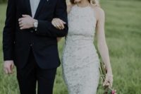 a sheath boho lace wedding dress with a halter neckline and an accented waist looks very modern and chic
