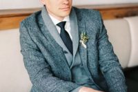 a stylish winter groom’s outfit with a white shirt, a grey cardigan, a grey tweed blazer, a black tie is very chic and cool