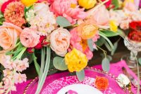 a super bright wedding place setting with bold blooms, hot pink accessories, a pink flamingo menu and card is wow
