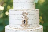a whimsical wedding cake that features a whole text and some blooms and grapes on top is a gorgeous idea for a book-lover wedding