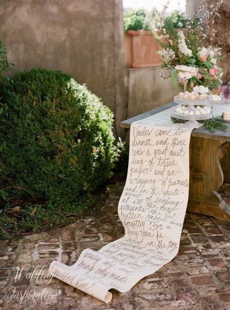 a white table runner with quotes is a cool idea for a reception or sweets wedding table is a creative solution