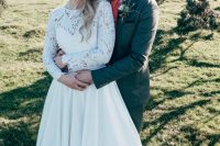 an A-line wedding gown with a lace bodice with long sleeves and a full plain skirt